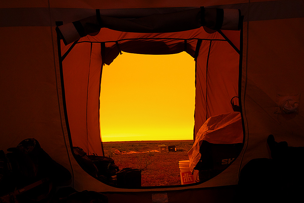 View from inside tent pitched south of Arviat showing smoke covered sky from forest fires in NWT.