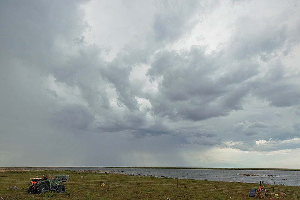 Storm clouds over arctic tundra.