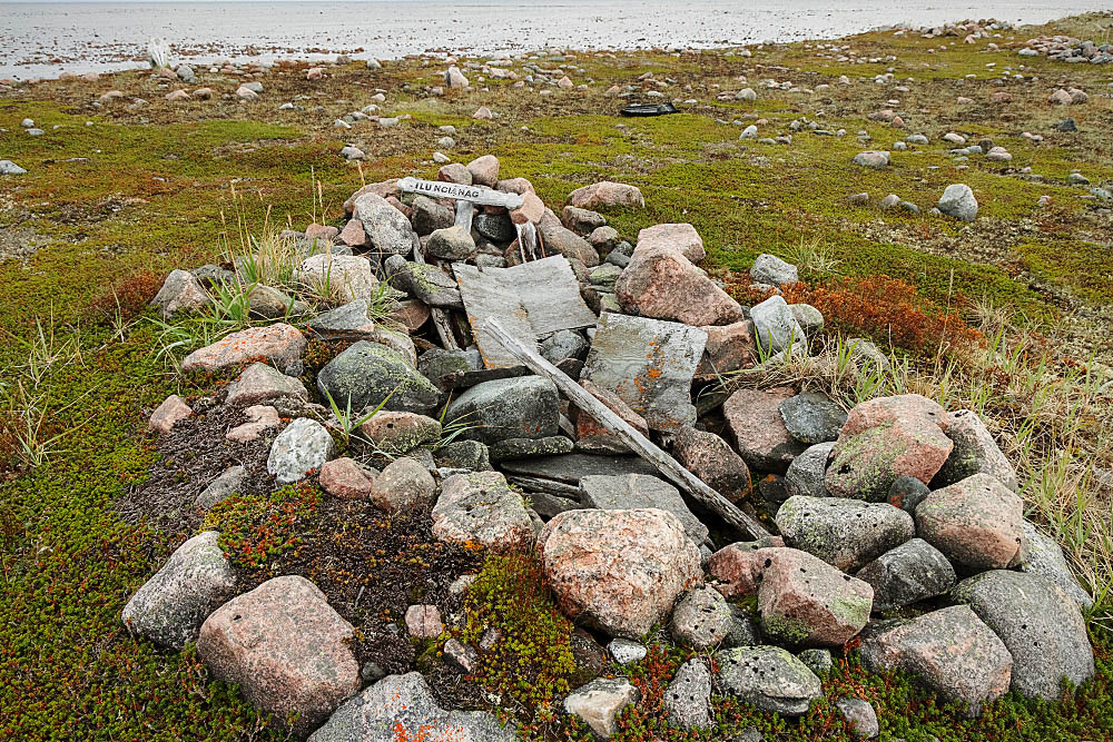 Old Inuit grave site on shoreline between the arctic tundra and Hudson Bay, Canada.