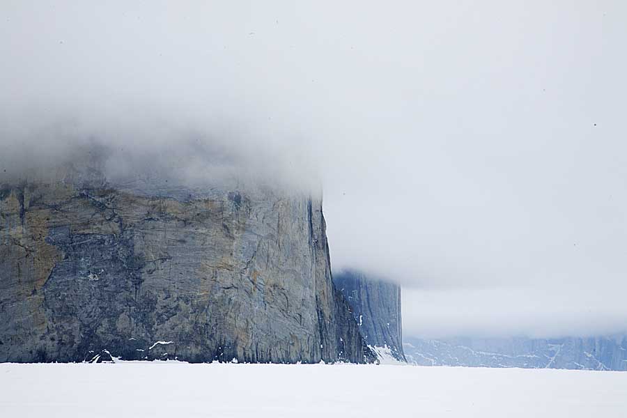 Sea ice and cliffs with cloud formation in arctic.