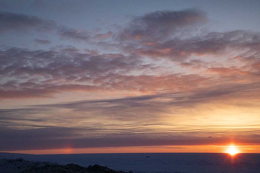 First light and sunrise of new year above arctic circle after 3 months of polar night.